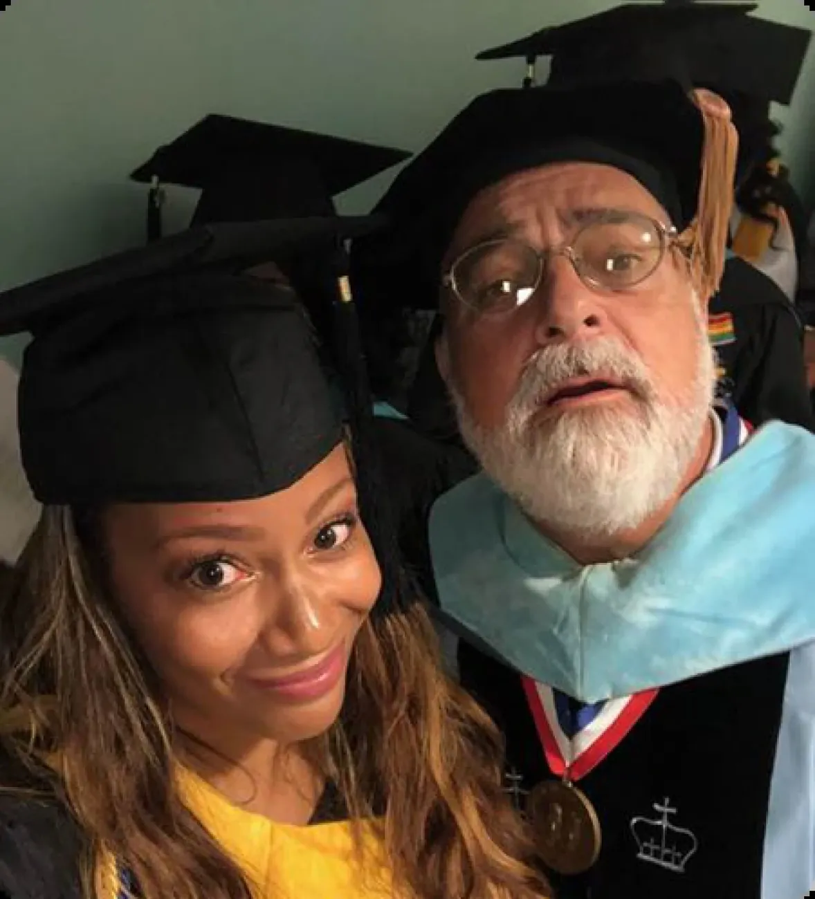 Graduates smiling in caps and gowns
